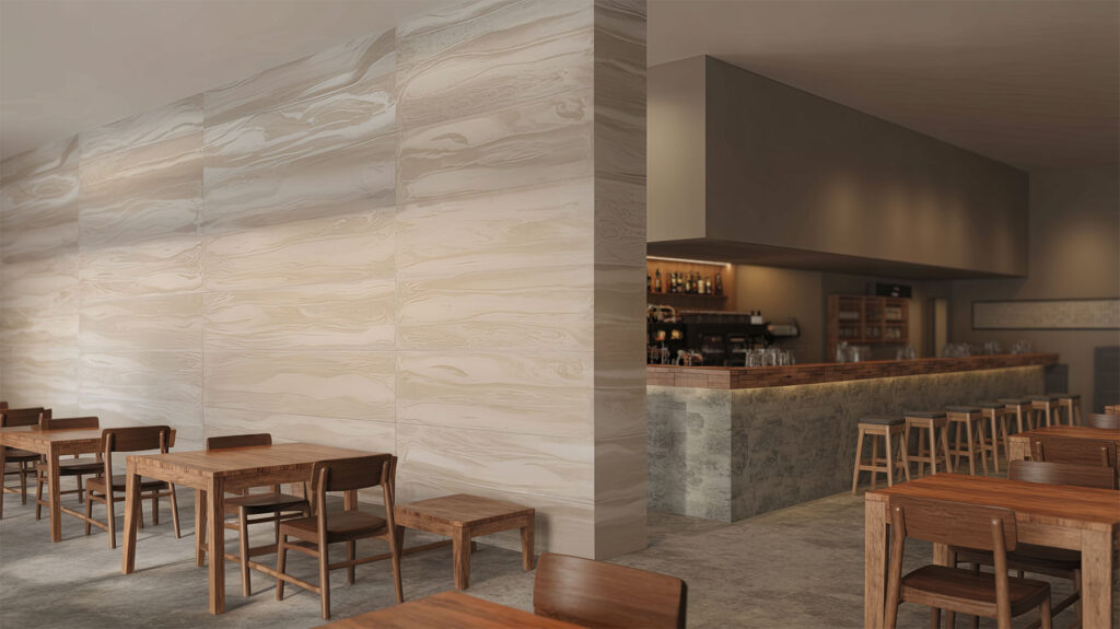 Modern cafe interior showcasing decorative wall paneling with a natural stone effect. The warm, beige handcrafted faux marble panels contrast with simple wooden tables and chairs, adding an organic element to the minimalist, industrial design.